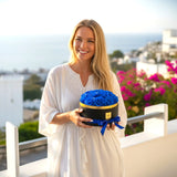Woman holding Floragram blue preserved roses gift box — romantic gift Canada
