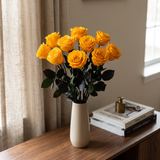 Yellow long stem preserved roses styled in a vase on a console table in a modern living room