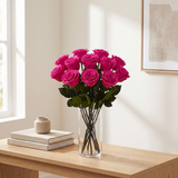 Fuchsia long stem preserved roses styled in a vase on a console table