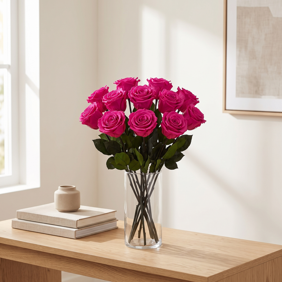 Fuchsia long stem preserved roses styled in a vase on a console table